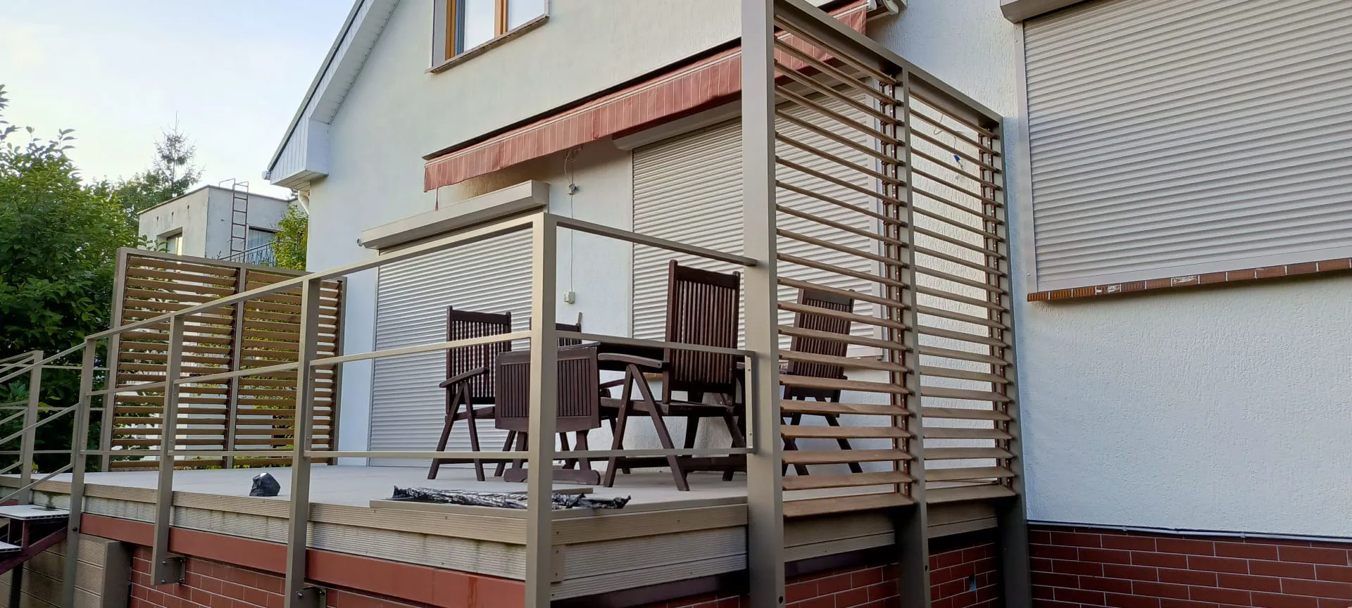Balkonterrasse mit Metallgeländer und Holzlamellen – Terrassenbau